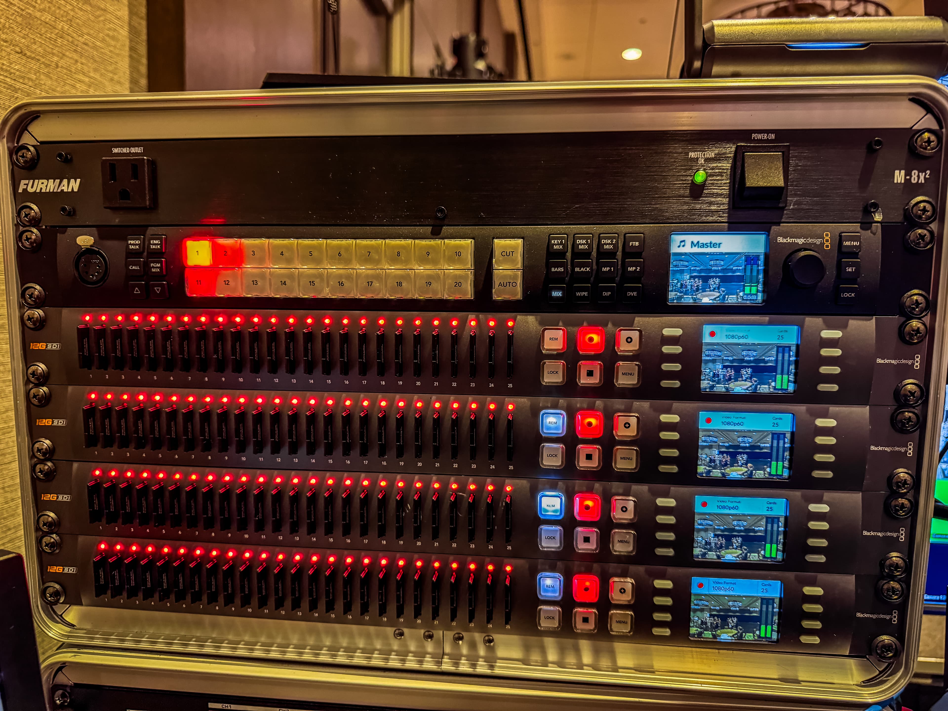Professional video production rack featuring Blackmagic Design equipment with numerous glowing red indicator lights.